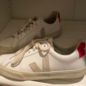 White sneaker with red accents